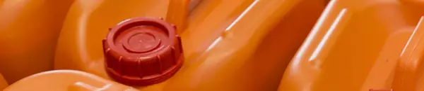 Themenbild mit Ausschnitt von orangen Behältern mit rotem Deckel für Chemikalien.